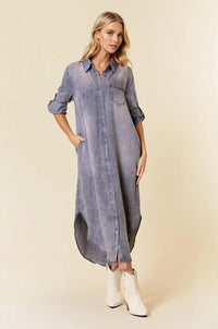 A long faded blue button-front midi dress with rolled sleeve tencel denim fabric and roll tab 3/4 sleeves