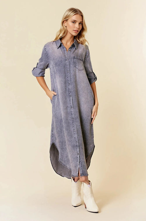 A long faded blue button-front midi dress with rolled sleeve tencel denim fabric and roll tab 3/4 sleeves