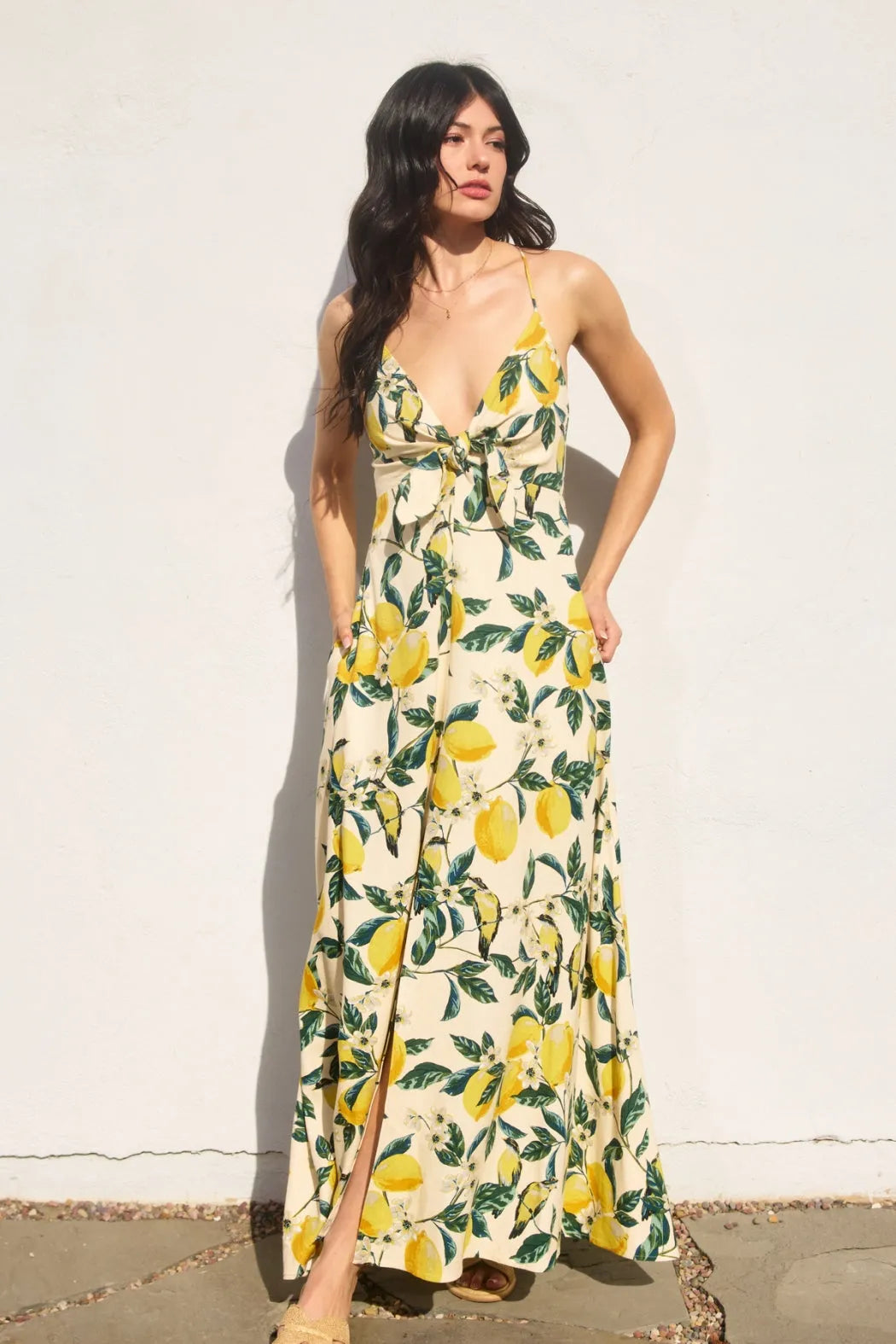 Vintage lemonade knot front maxi dress featuring a flowing lemon print fabric with long sleeves deep v neckline and side slit
