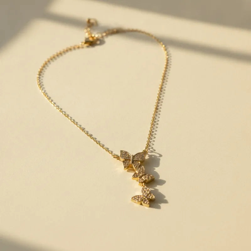 Luxury dainty gold plated necklace with three butterfly pendants featuring sparkling clear stones in a cascading design