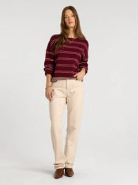 A maroon and cream striped knit supply ely sweater with relaxed fit ribbed cuffs and hem in thread and supply