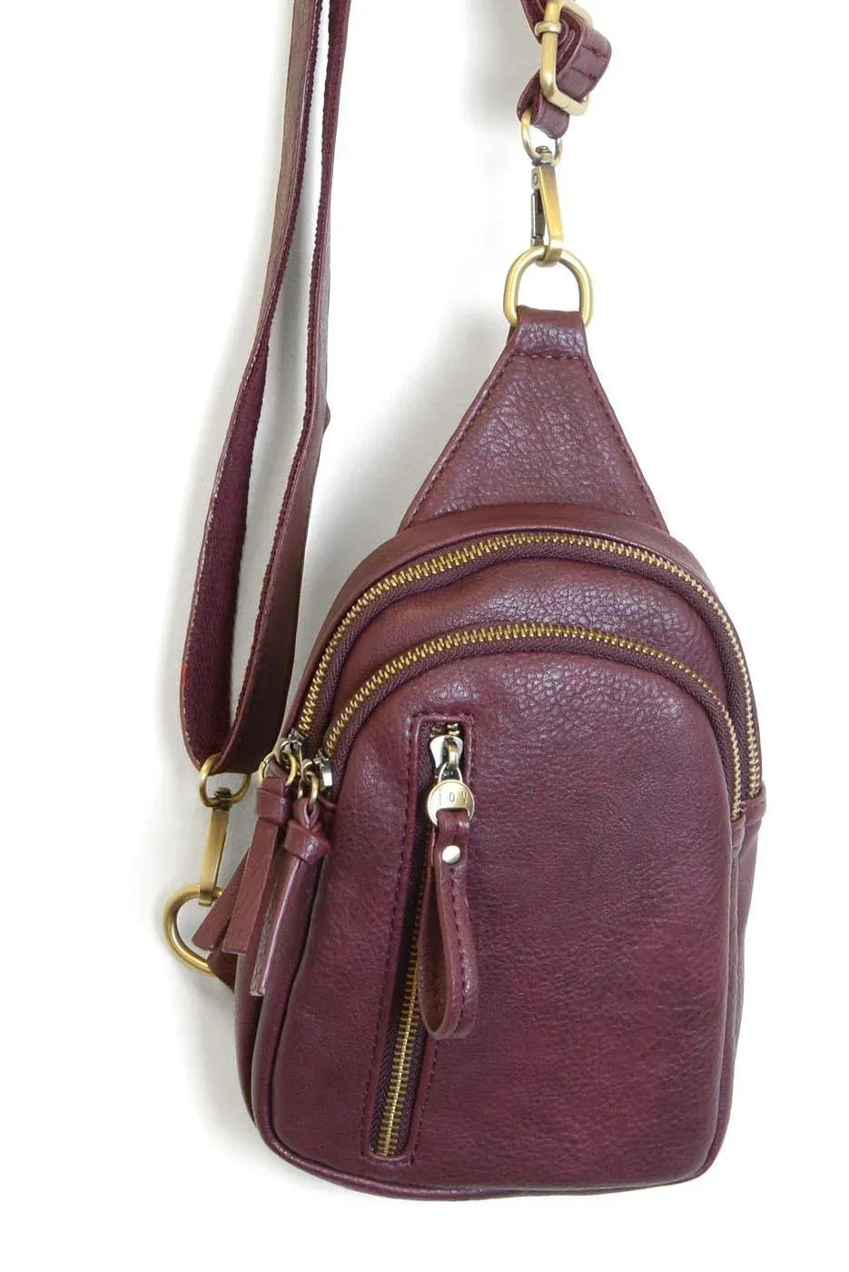 Skyler sling bag maroon leather crossbody bag with multiple gold-toned zippers and hardware