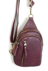 Skyler sling bag maroon leather crossbody bag with multiple gold-toned zippers and hardware
