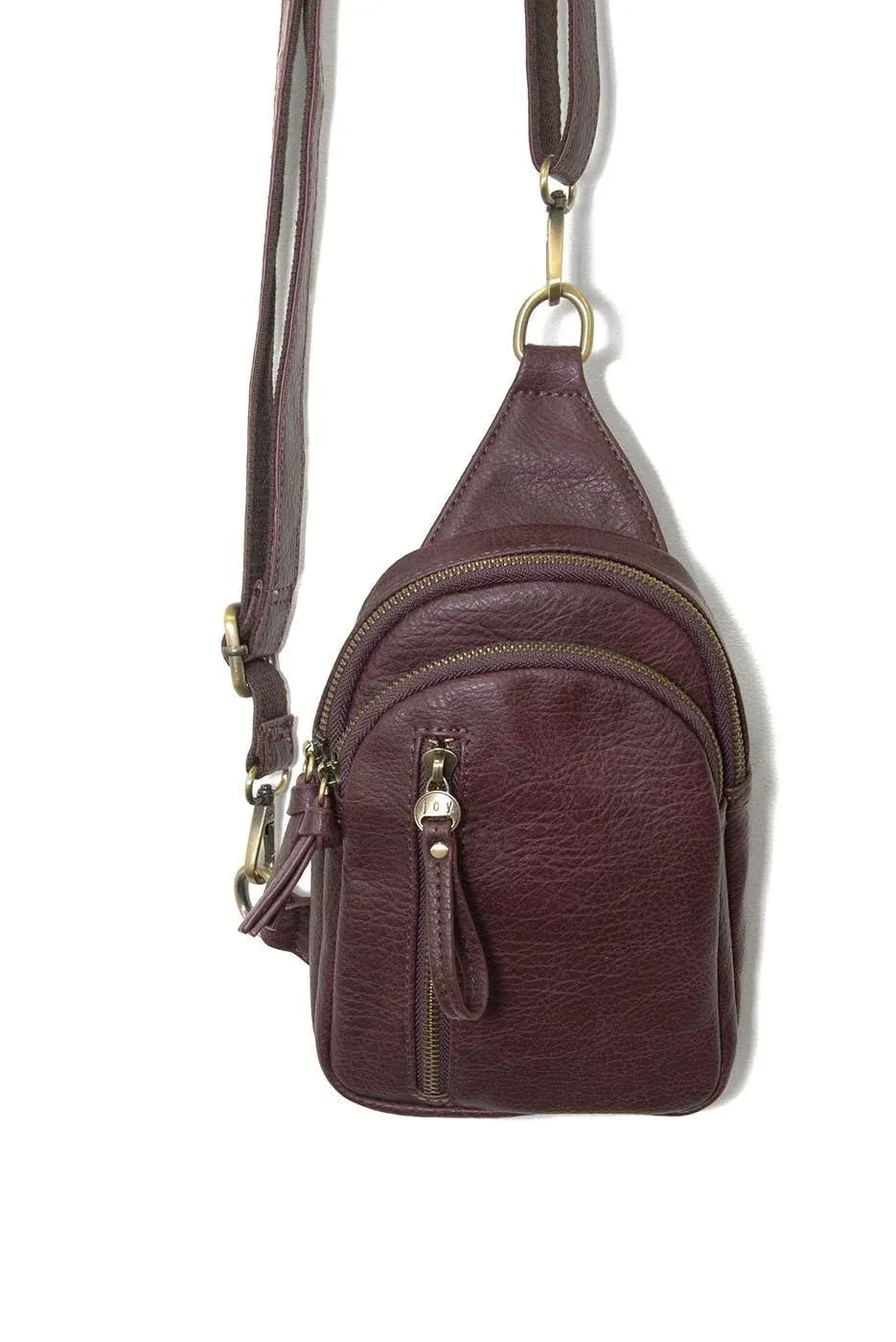 Skyler sling bag is a maroon leather crossbody bag with multiple zippers and a gold-tone metal clasp