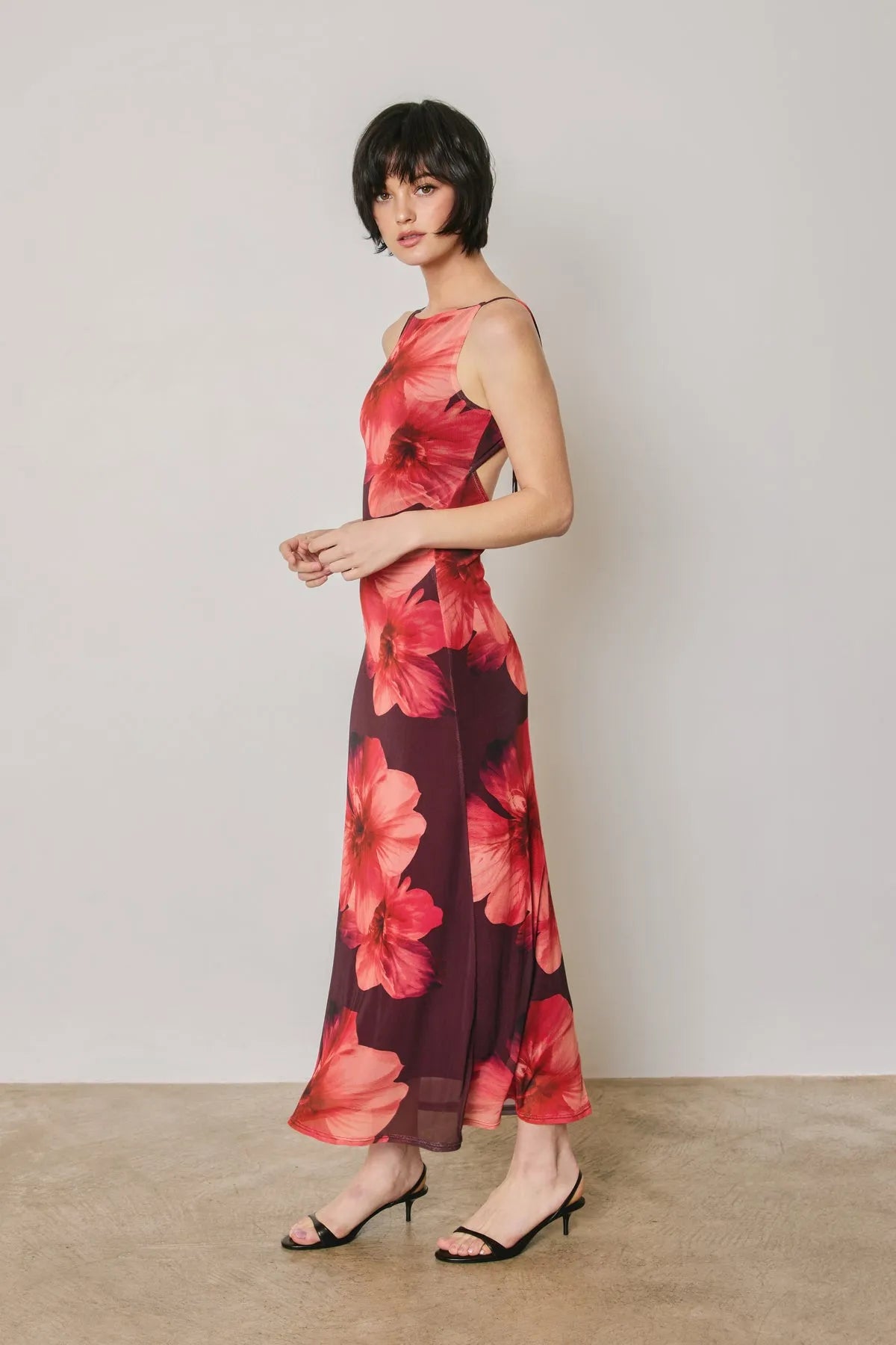 Flowing maxi dress in vibrant red floral mesh print on burgundy with delicate open back cut-out details
