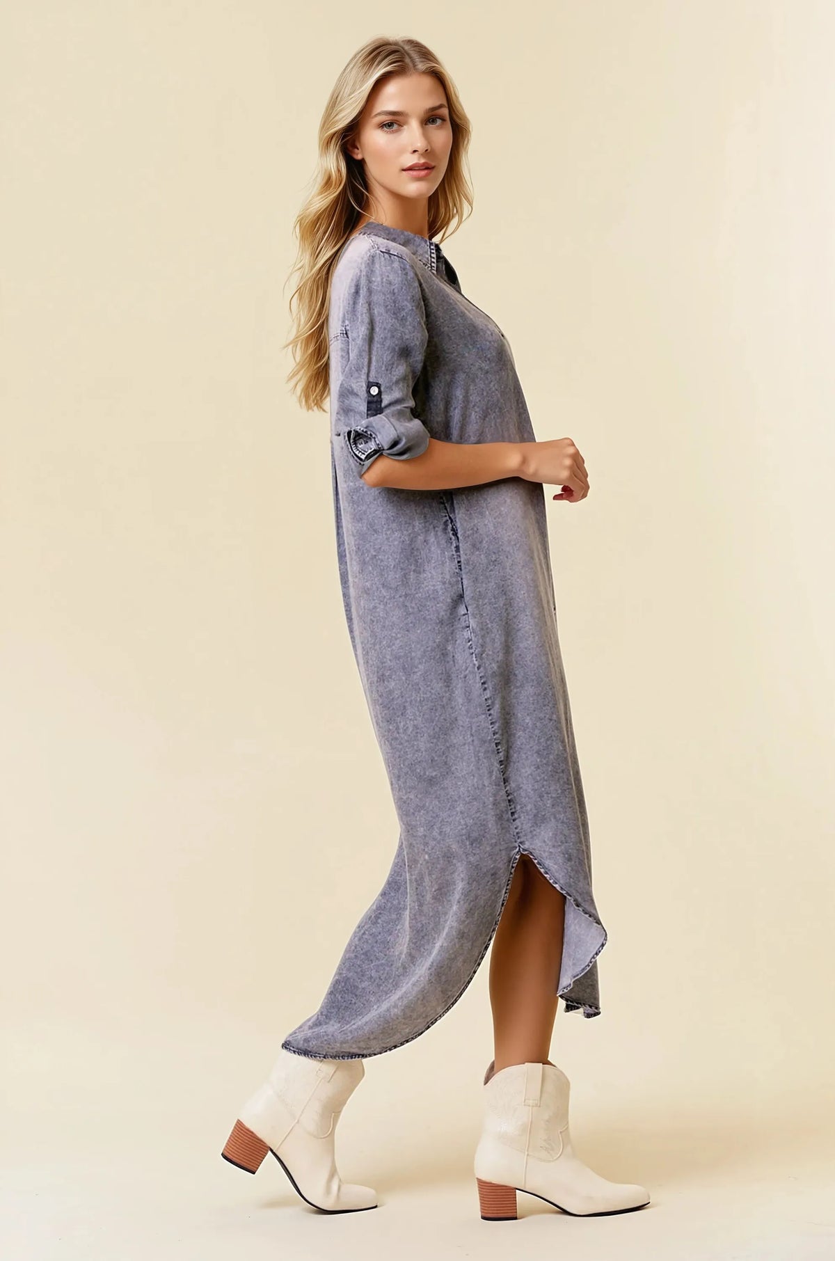 A flowing medium-wash tencel denim shirt midi dress with rolled-up sleeve tencel denim and a high side slit