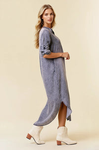 A flowing medium-wash tencel denim shirt midi dress with rolled-up sleeve tencel denim and a high side slit