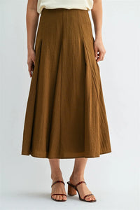 A rich brown godet midi skirt with subtle pleats and lightweight fabric featuring a side zipper closure