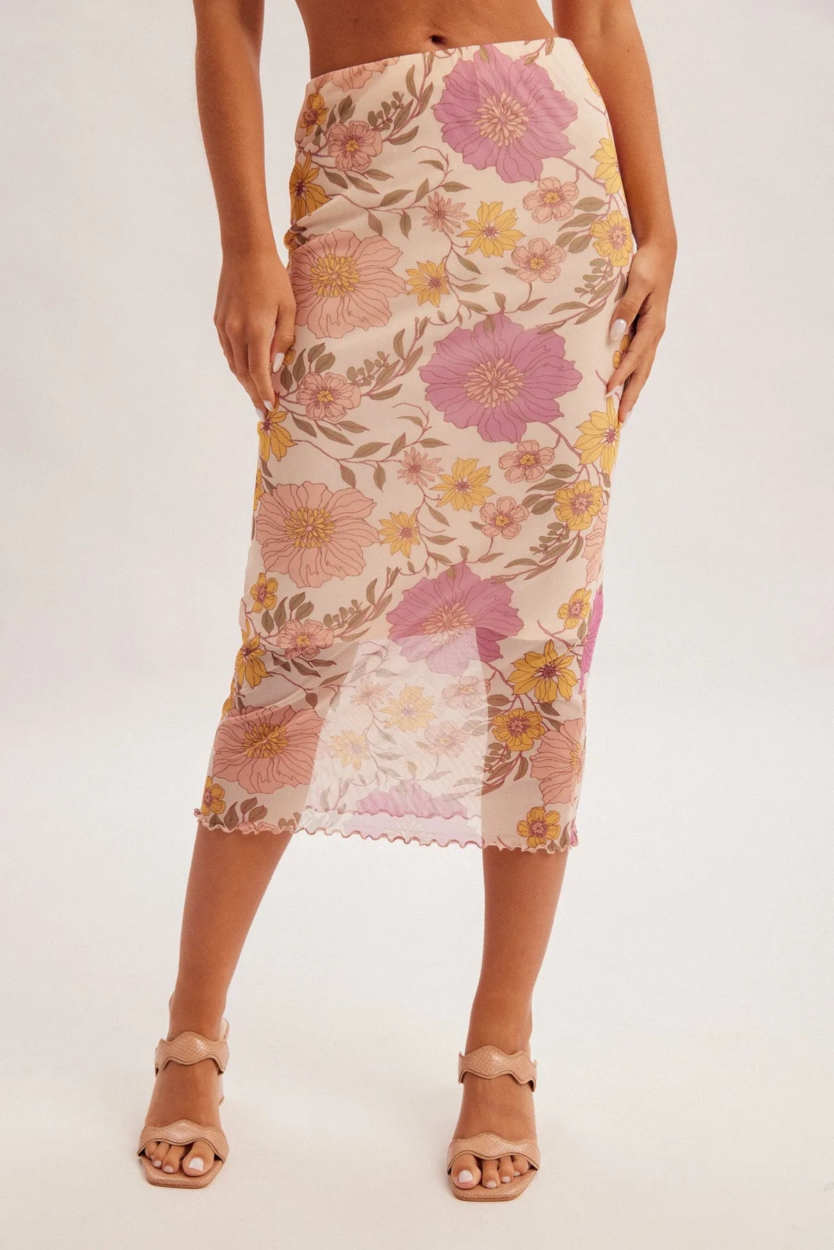 A floral print midi mesh skirt in soft beige mesh fabric with vibrant pink and yellow blossoms and green leaves