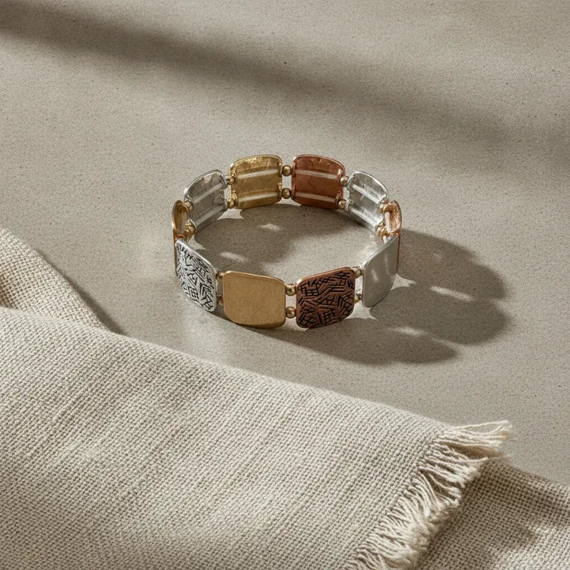 Bohemian mixed metal stretch bracelet with gold rose gold and silver engraved rectangular links in a metal stretch design