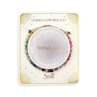 Chakra glow bracelet set featuring multicolored green pink purple and black beads with gold accents in circular design