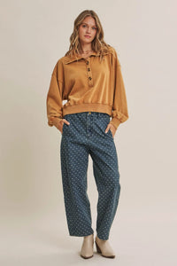 Mustard-yellow oversized button-up sweatshirt with ribbed cuffs paired with jacquard polka dot barrel leg jeans