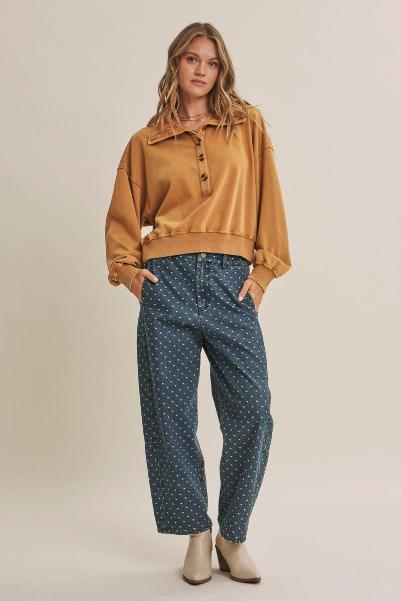 Mustard-yellow oversized button-up sweatshirt with ribbed cuffs paired with jacquard polka dot barrel leg jeans
