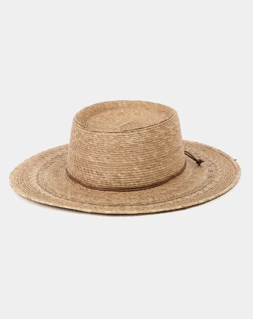 Natural straw palm leaf beach hat with wide brim and woven texture ideal for sun protection at the beach