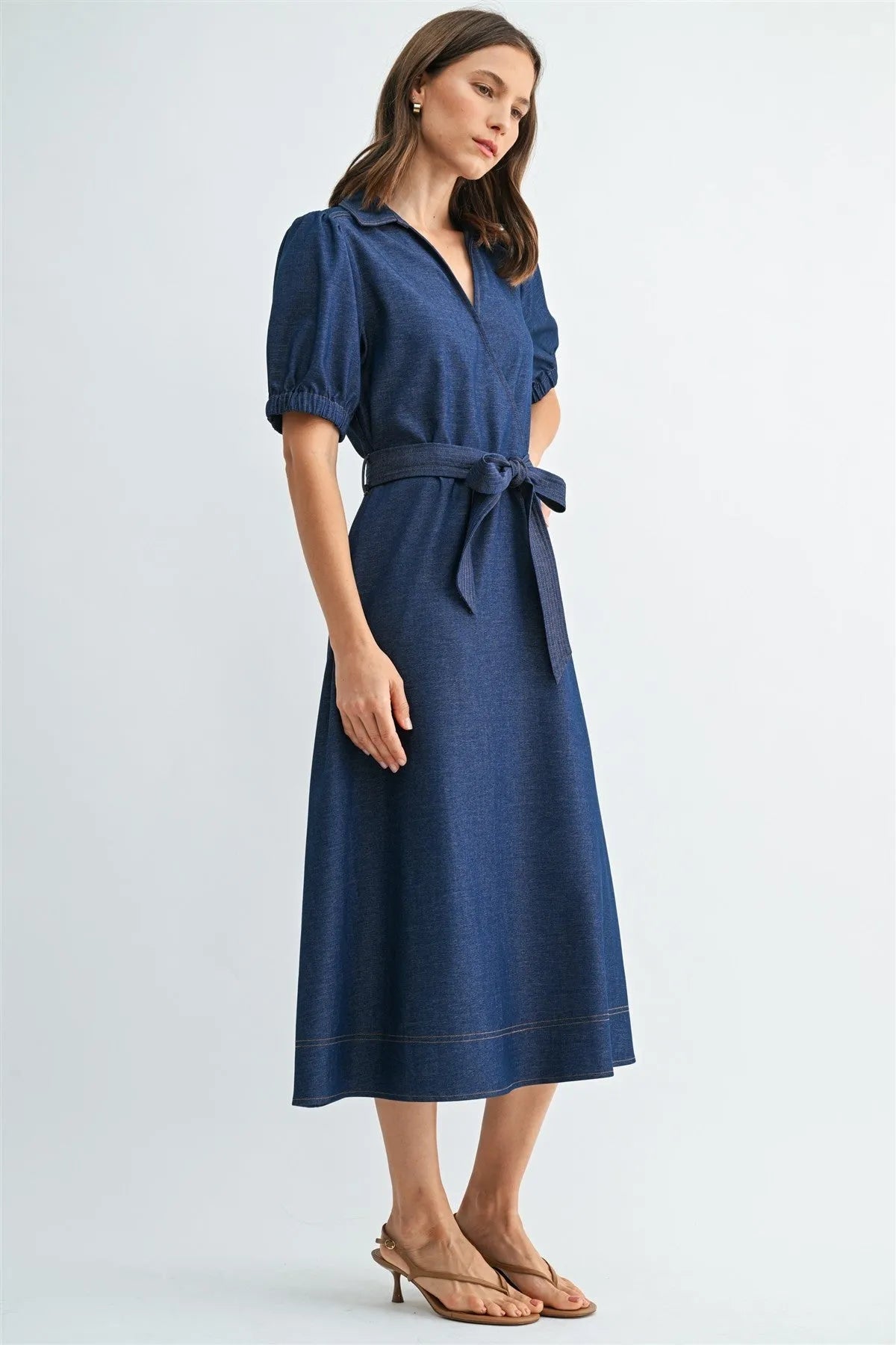 A navy blue denim short sleeve wrap tie waist midi dress with collar and puffed sleeves