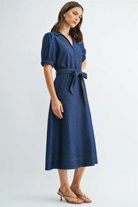 A navy blue denim short sleeve wrap tie waist midi dress with collar and puffed sleeves