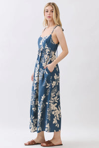 Navy blue floral cami midi dress with cream blossoms featuring thin straps and a tie-side waist detail