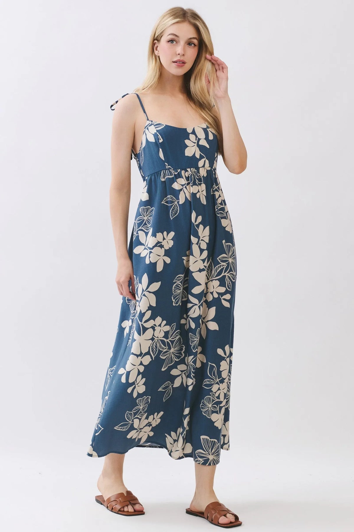 Navy blue floral cami midi dress with delicate white blossoms thin spaghetti straps and gathered waist details