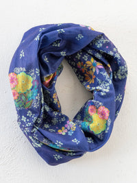 A navy blue boho bandeau scarf with vibrant yellow pink and orange blossoms and small white flowers tropic bandana navy