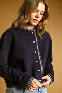 Navy blue knit cardigan with plaid contrasted button front cream buttons and plaid collar and cuffs
