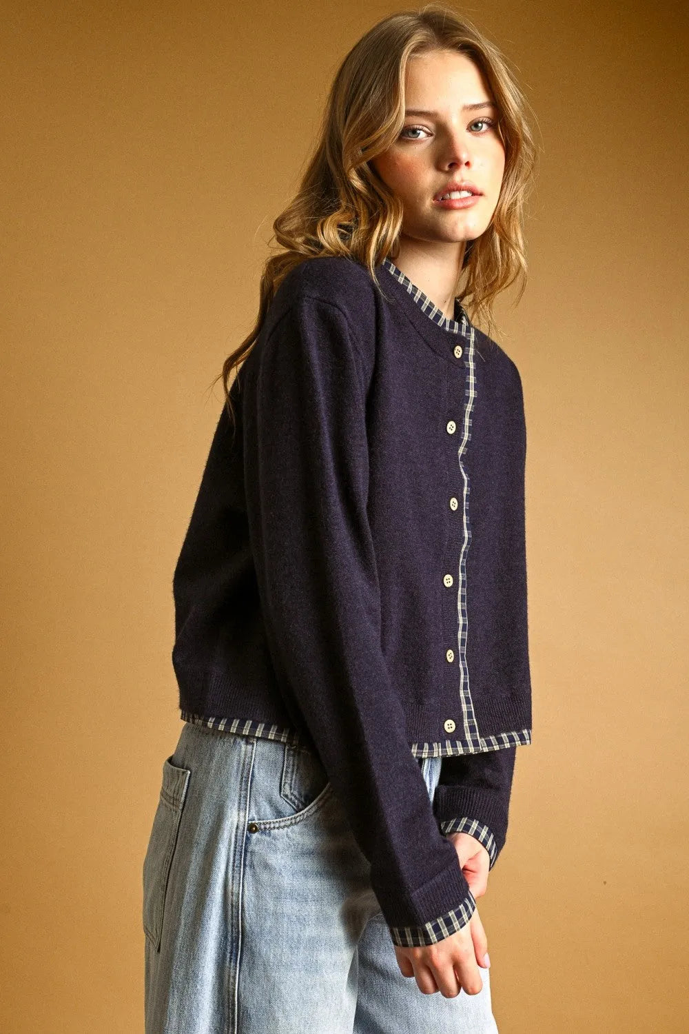 Navy blue knit cardigan with plaid contrasted button front trim along collar and cuffs for stylish layering