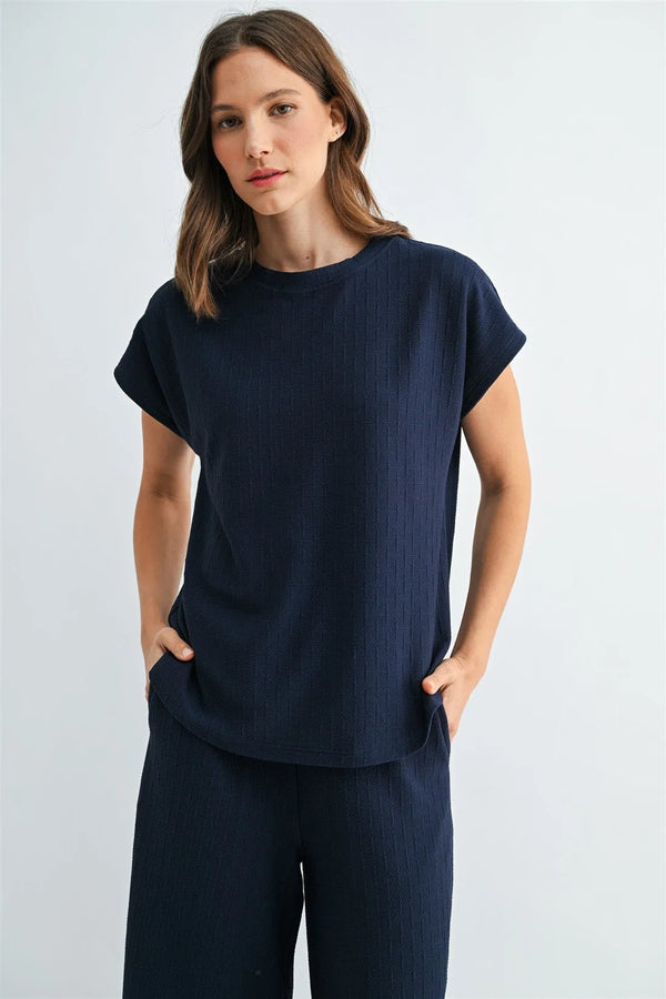 Navy blue textured knit dolman top in ribbed cotton with short sleeves and side pockets for casual wear