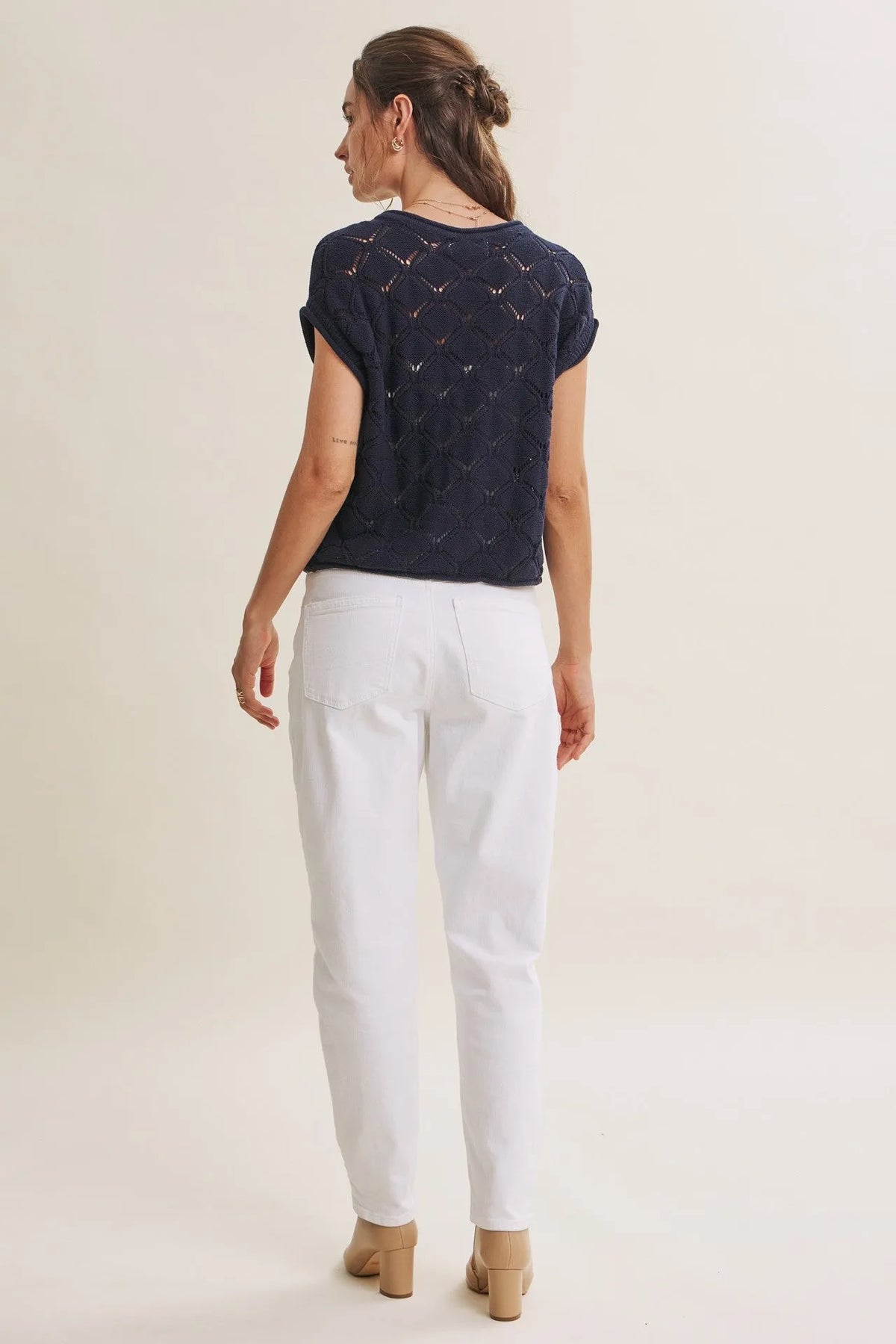 Navy blue short-sleeved harbor cable knit cotton sweater top with textured diamond-patterned design
