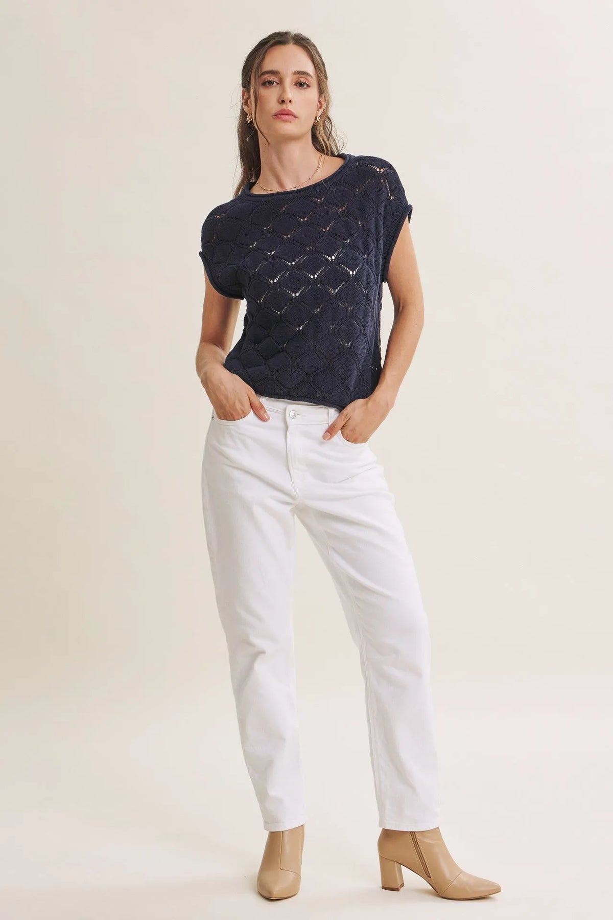Navy blue short-sleeved harbor cable knit cotton sweater top with textured diamond-patterned design