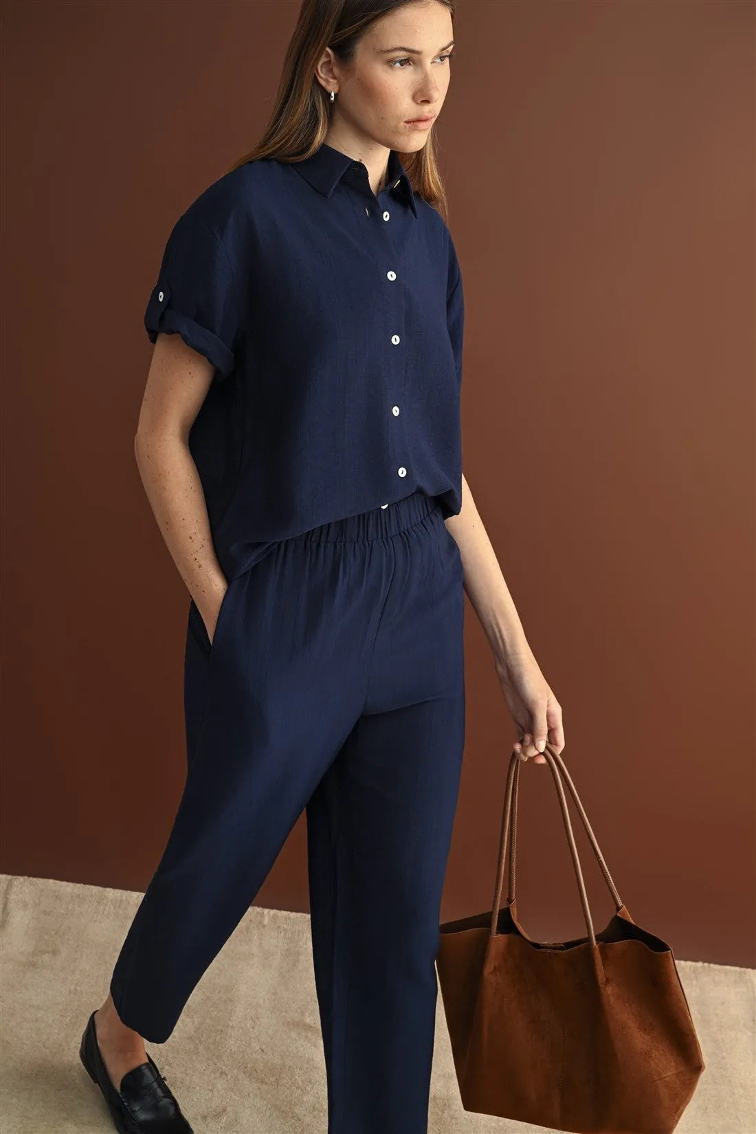 Navy blue roll up short sleeve button down shirt with rolled cuffs and relaxed fit for casual wear