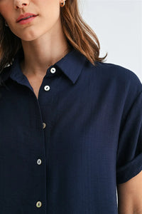 Navy blue roll up short sleeve button down shirt with white sleeve buttons for casual or office wear