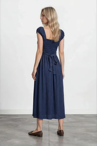 A navy blue sleeveless midi dress with square neckline and gathered waist tied with matching fabric belt smocked midi dress