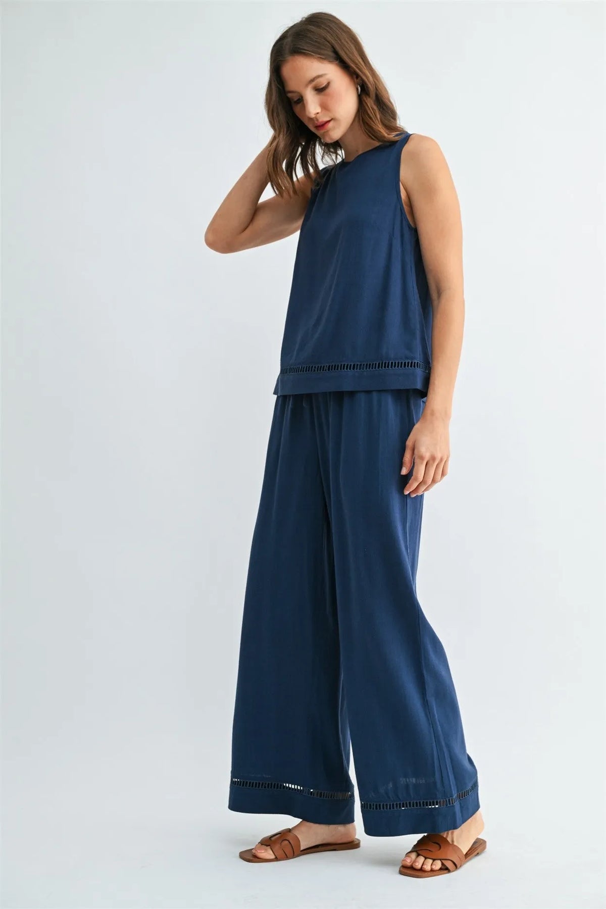 Navy blue sleeveless top with delicate eyelet trim along hem and waistband complements drawstring trim pants in women’s boho chic clothing from shop daisy