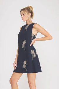Navy blue sleeveless mini dress with gold palm tree embroidered detailing perfect for elegant summer wear