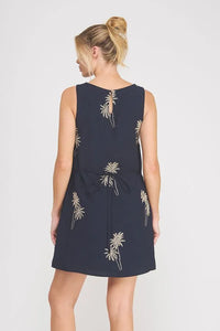 Navy blue mini dress with gold palm tree embroidered detail and a tied waistband for elegant wear