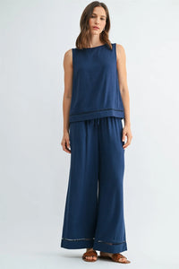 Navy blue sleeveless round neck trim tank with delicate lace trim along the hem and waistband