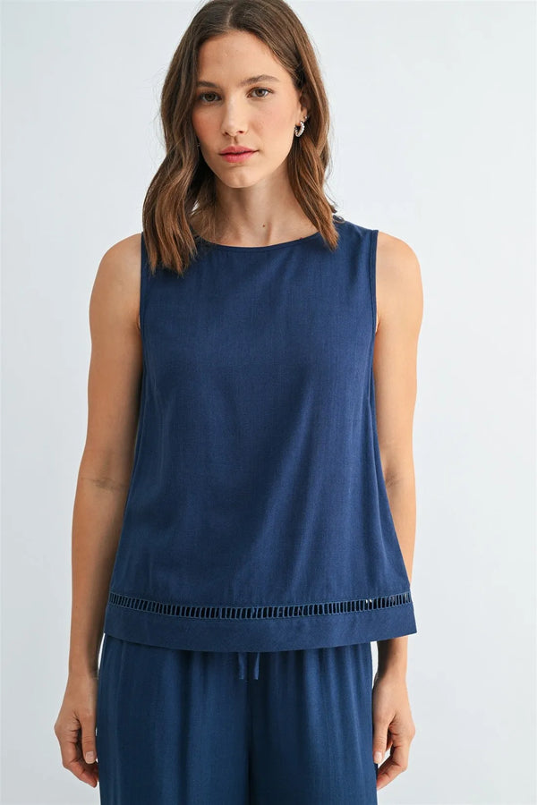 Navy blue sleeveless round neck tank with subtle textured fabric and decorative fringe trim along the hem