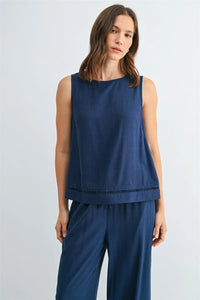 A navy blue round neck trim tank top with a subtle textured hemline featuring a sleeveless design