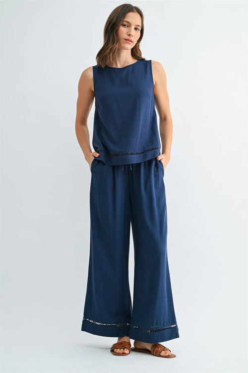 Navy blue sleeveless round neck trim tank with subtle eyelet hem and side pockets for casual wear