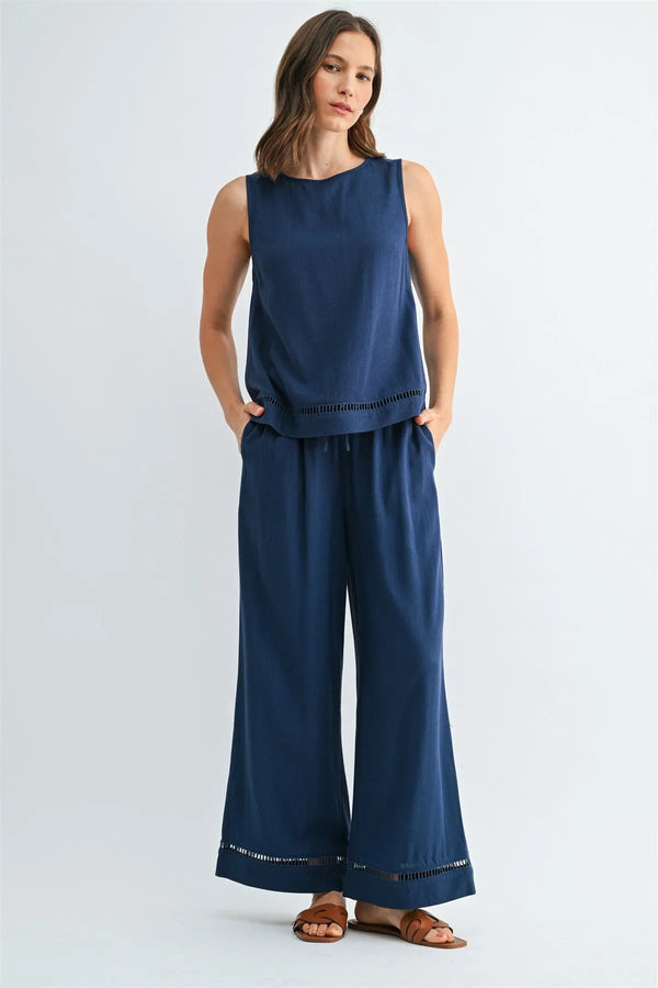 Navy blue sleeveless round neck trim tank with subtle eyelet hem and side pockets for casual wear