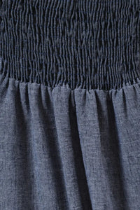 Navy blue sweet heart neck spaghetti strap midi dress with smocked waistband and flowing slightly wrinkled skirt fabric