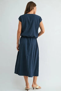 Navy blue softly pleated midi dress with relaxed fit and short sleeves paired with boxy elastic waist blouse