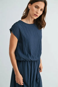 Navy blue boxy elastic waist blouse with short sleeves and soft pleats in a relaxed fit style
