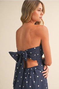 Navy blue polka dot tube maxi dress with strapless design and elegant back bow tie detail showing the back side