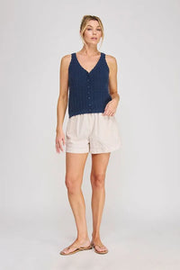 Navy blue textured knit sleeveless top with button front featuring tie elastic waist and elastic waist pockets
