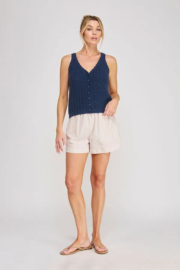 Navy blue textured knit sleeveless top with button front featuring tie elastic waist and elastic waist pockets