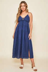 Navy blue tiered maxi dress with thin spaghetti straps and front tie detail in a plaid print tie maxi style