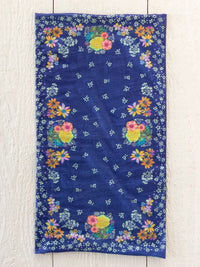 A navy blue full boho bandeau headband with vibrant yellow, pink, orange, and white floral patterns tropic bandana navy