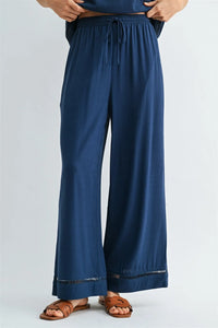 Navy blue wide-leg drawstring trim pants with fringe hem for women’s boho chic clothing shop daisy collection