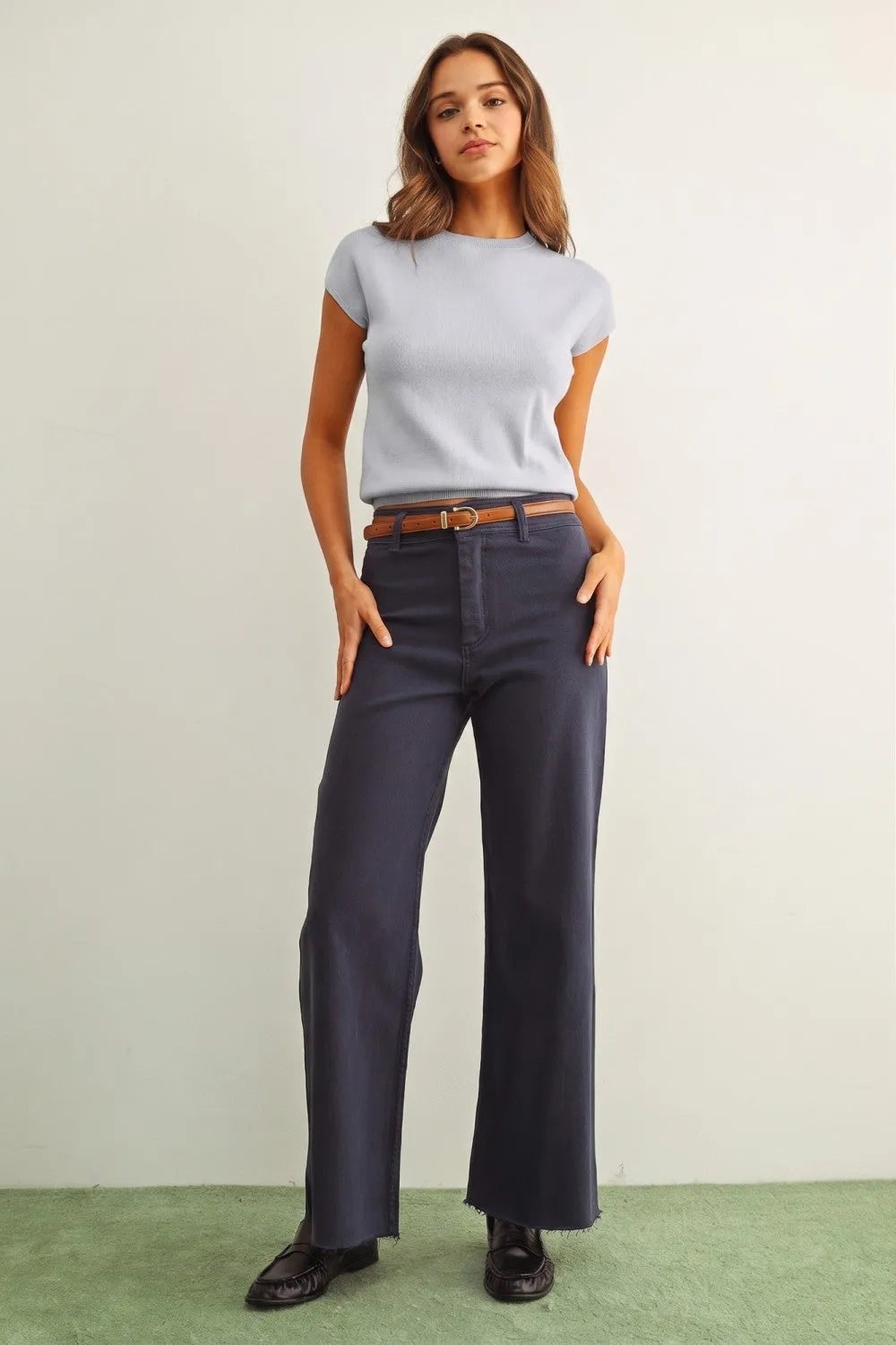 Navy blue wide-leg trousers with frayed hem and belt loops paired with a round neck cap short sleeve knit top