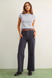 Navy blue wide-leg trousers with frayed hem and belt loops paired with a round neck cap short sleeve knit top